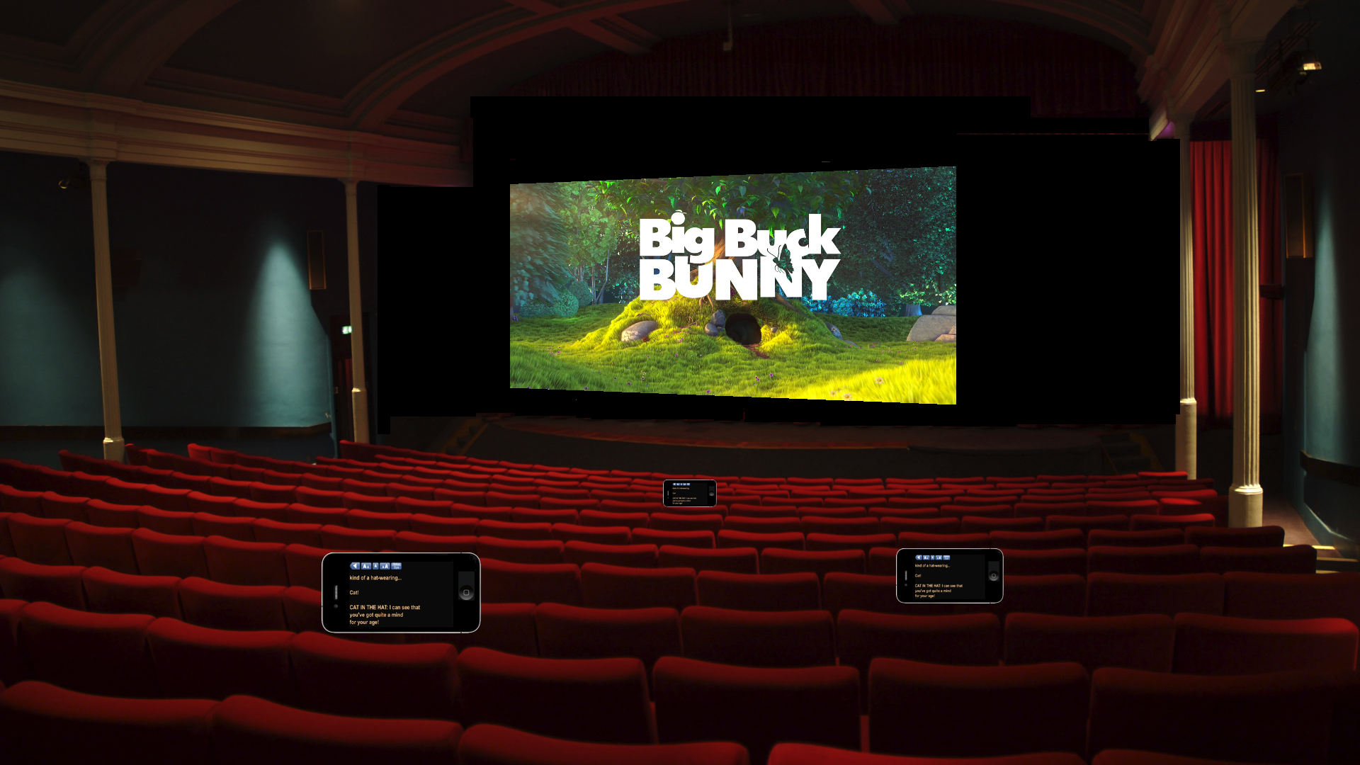 A theater interior. There are iphones at a few seats showing captions.